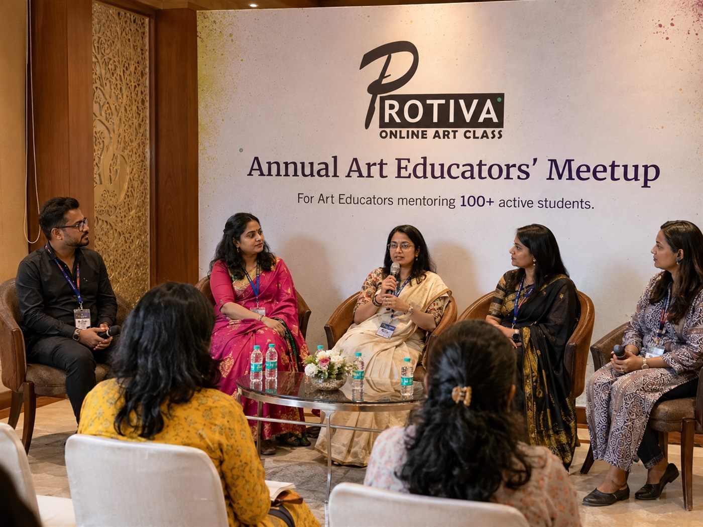 Art educators discussing teaching ideas during a panel session